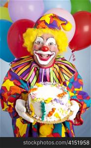 Crazy clown with balloons, holding a birthday cake.
