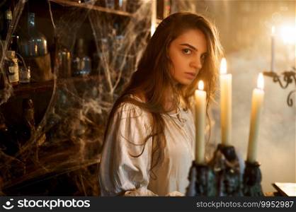 Crazy demonic woman near the shelf with potions, demons casting out. Exorcism, mystery paranormal ritual, dark religion, night horror. Crazy demonic woman near the shelf with potions