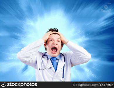 Crazy doctor. Image of young male doctor screaming in madness