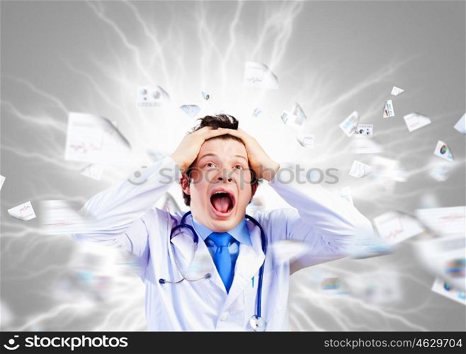 Crazy doctor. Image of young male doctor screaming in madness