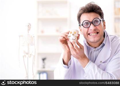 Crazy doctor studying human skeleton