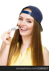 Crazy fun people concept. Girl with chewing gum. Young woman has cap and long hair.. Girl with chewing gum.