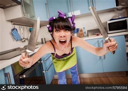 Crazy funny housewife in an interior of the kitchen