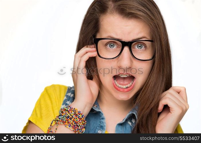 Crazy girl in braces wearing geek glasses on white background