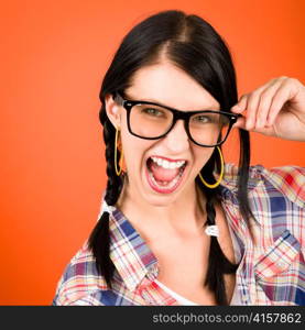 Crazy girl wear nerd glasses shouting on orange background