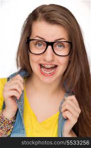 Crazy girl with braces wearing geek glasses on white background