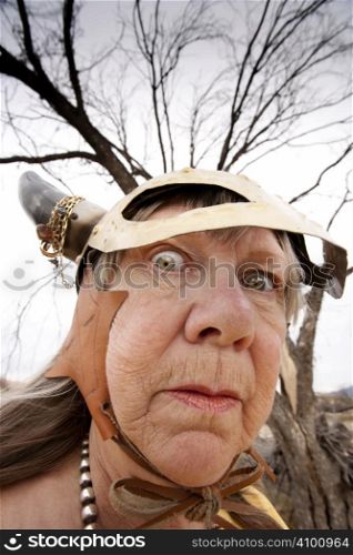 Crazy old woman wearing a Viking helmet