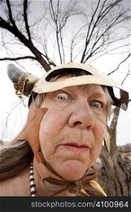 Crazy old woman wearing a Viking helmet