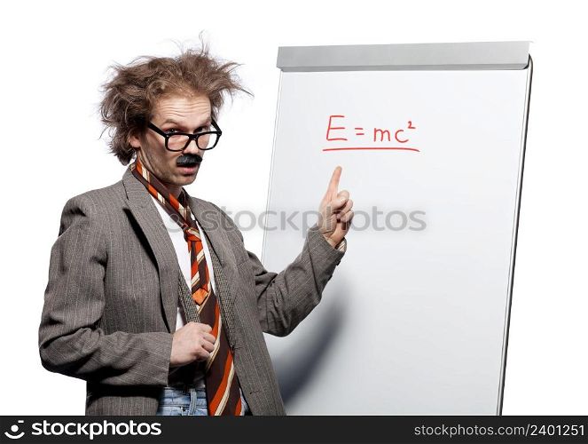 Crazy professor / scientist / lecturer with mad hairstyle wearing horn rimmed glasses and fake mustache standing in front of a whiteboard and pointing e=mc2