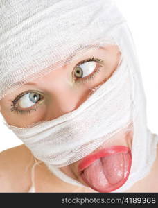 Crazy woman with bandages on her face on white