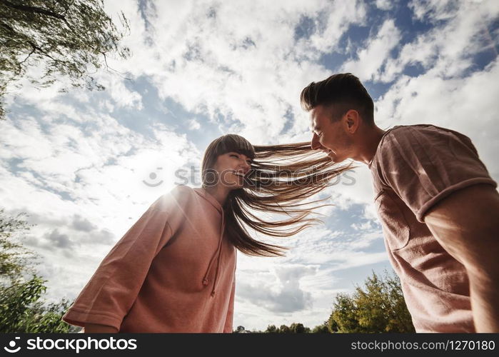 crazy young couple emotionally having fun, kissing and hugging outdoors. Love and tenderness, romance, family, emotions, fun. having fun together