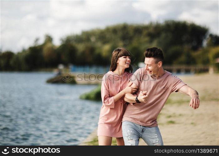 crazy young couple emotionally having fun, kissing and hugging outdoors. Love and tenderness, romance, family, emotions, fun. having fun together