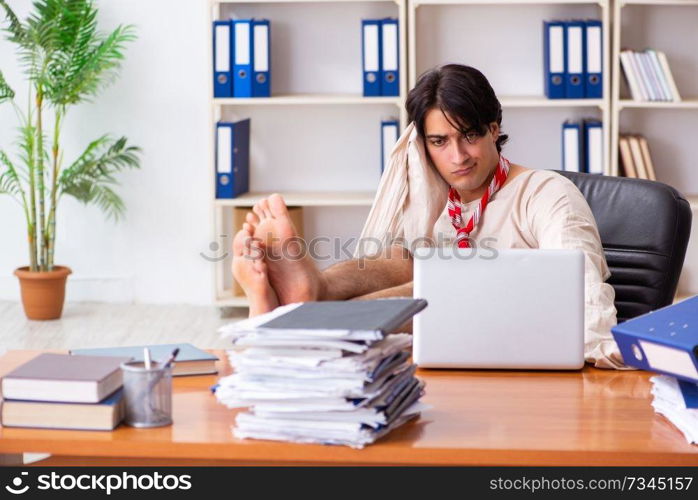 Crazy young man in straitjacket at the office 