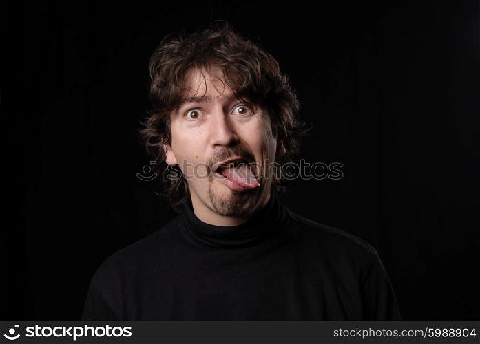 crazy young man portrait isolated on black