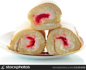 Cream and Strawberry rolls on a plate