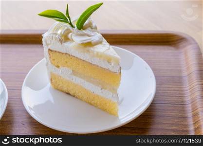 Cream cake placed on a wooden plate