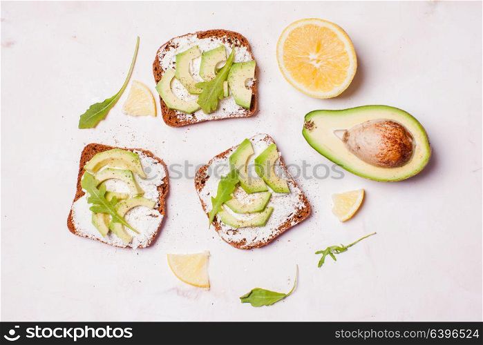Cream cheese and avocado sandwiches on the table. Cream cheese and avocado sandwiche