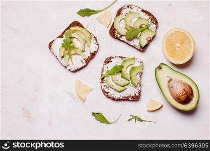 Cream cheese and avocado sandwiches on the table. Place for text, copy space. Cream cheese and avocado sandwiche