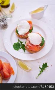 Cream cheese, Smoked salmon and poached egg toasts on a plate.. Cream cheese, Smoked salmon and poached egg toasts on a plate