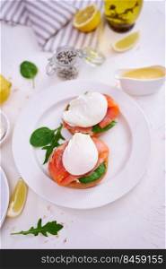 Cream cheese, Smoked salmon and poached egg toasts on a plate.. Cream cheese, Smoked salmon and poached egg toasts on a plate