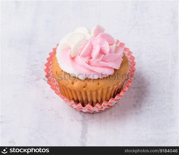 cream cupcake on white background, close-up. sweets on white background