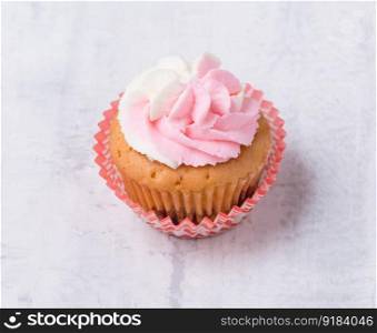 cream cupcake on white background, close-up. sweets on white background