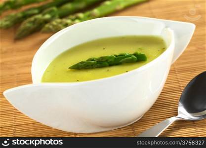 Cream of green asparagus (Selective Focus, Focus on the asparagus head on the soup). Cream of Asparagus