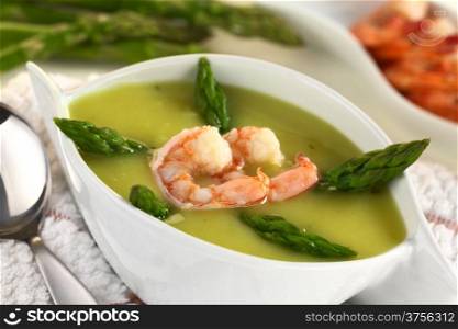 Cream of green asparagus with shrimp (Selective Focus, Focus on the lower edge of the shrimp). Cream of Asparagus with Shrimp