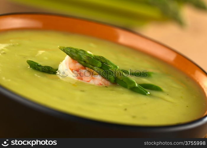 Cream of green asparagus with shrimp (Selective Focus, Focus on the upper asparagus head on the soup). Cream of Asparagus with Shrimp