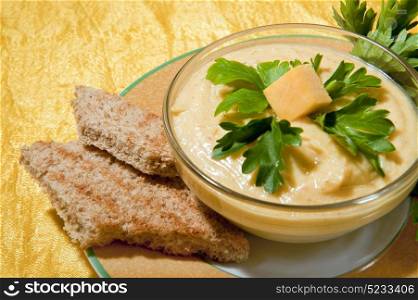 cream of pumpkin and shrimp with nutmeg and parsley on a colored background