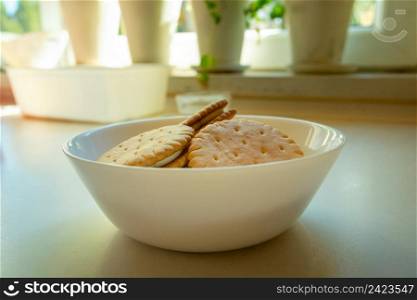 Cream sandwich cakes in a white bowl on the countertop, close up