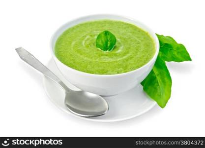 Cream soup green from spinach in a white bowl with leaf spinach on a plate, spinach leaves isolated on white background