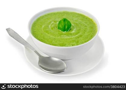 Cream soup green from spinach in a white bowl with leaf spinach on a plate isolated on white background