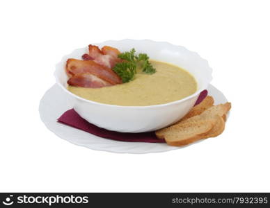 Cream soup with bacon and croutons on an isolated background. Cream soup with bacon and croutons
