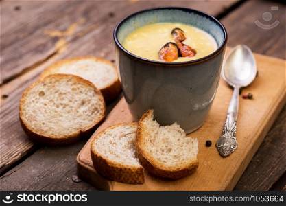 cream soup with mussels in a cup