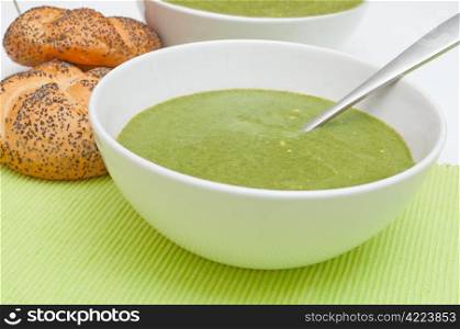 Cream Soup with Spinach in White Bowl and Bread Rolls