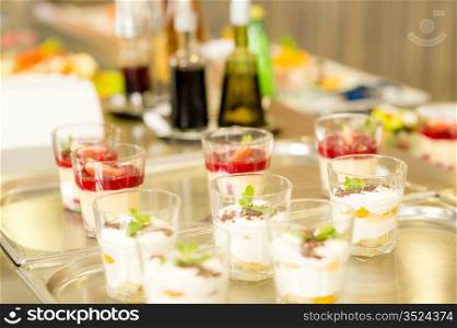 Creamy cup desserts on silver tray cafeteria delicatessen