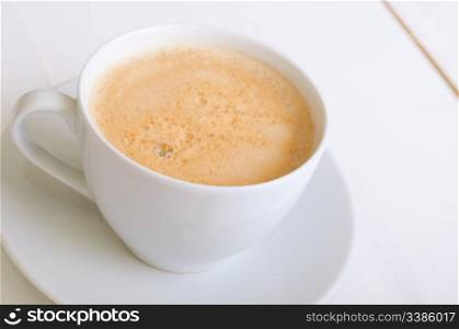 Creamy Espresso Coffee in White Cup on Table
