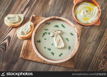 Creamy mushroom soup with toasted baguette and hummus