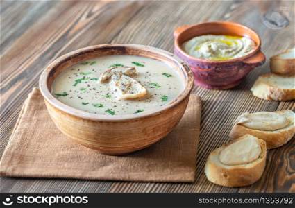 Creamy mushroom soup with toasted baguette and hummus