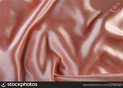 creamy satin background. A satiny fabric with beautiful light-shadow waves