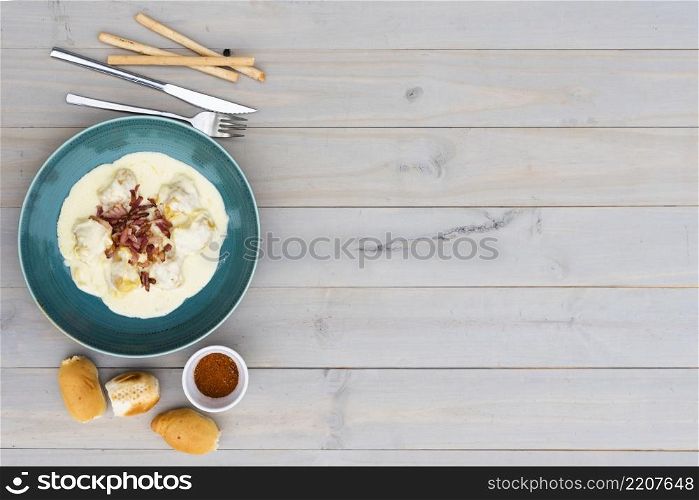 creamy tasty italian pasta ceramic plate with bread meal wooden background