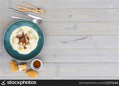 creamy tasty italian pasta ceramic plate with bread meal wooden background