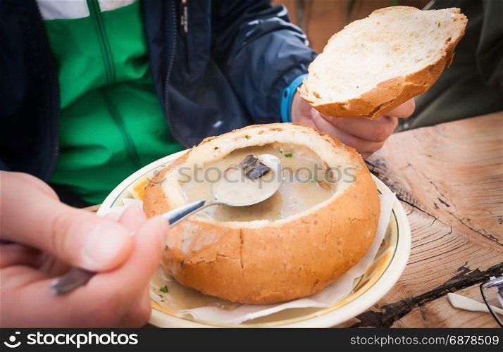Creamy wild mushroom soup served in a bowl of bread. Typical mountain dish.