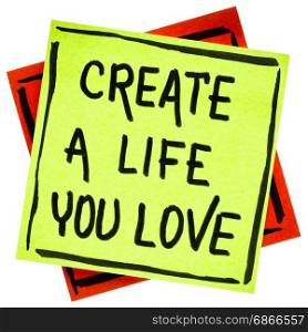 Create a life you love advice or reminder - handwriting in black ink on an isolated sticky note