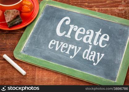 Create every day motivational reminder - motivational text on a slate blackboard with chalk and cup of tea