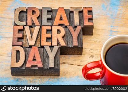 create every day words in vintage letterpress wood type printing blocks against painted wood with a cup of coffee