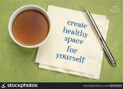 create healthy space for yourself - inspirational text on a napkin with a cup of tea