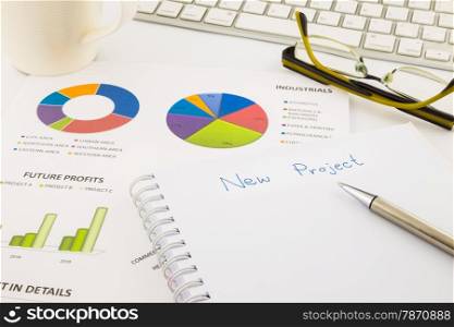 create ideas for new project, graph and chart with blank paper on office table, business concept
