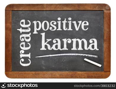 create positive karma - motivational text on a vintage slate blackboard